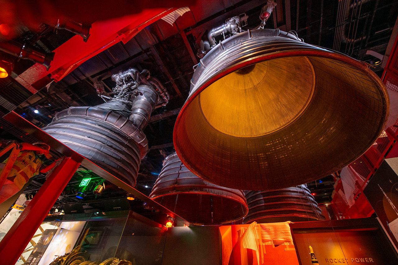 Mirrors create the illusion of standing under the Saturn V inside the flame trench, but in reality there is only one complete F-1 and a quarter section from an example of a center-mounted engine in the 