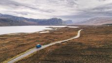 A solitary caravan is stopped next to Loch Eriboll on the North Coast 500