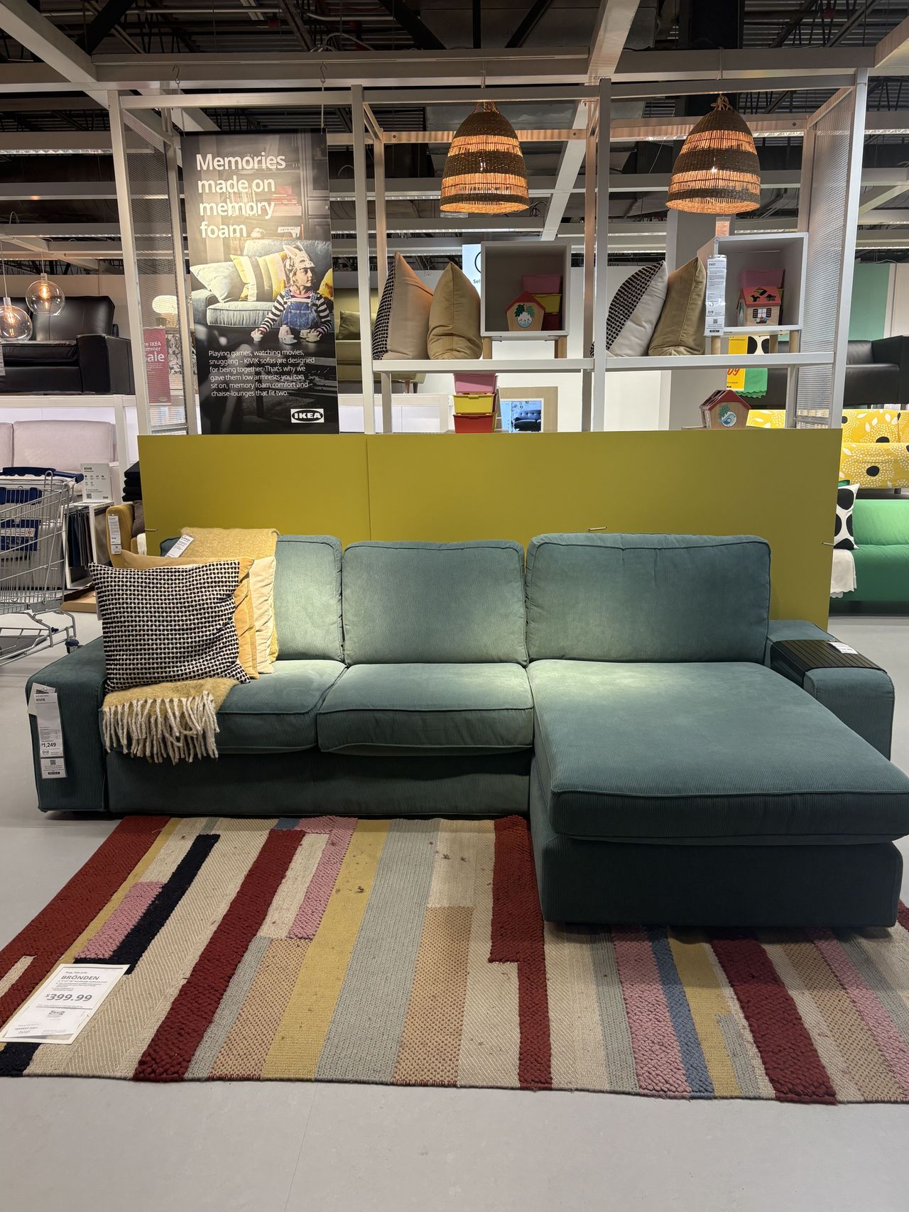 A blue sectional sofa sitting in an IKEA showroom.