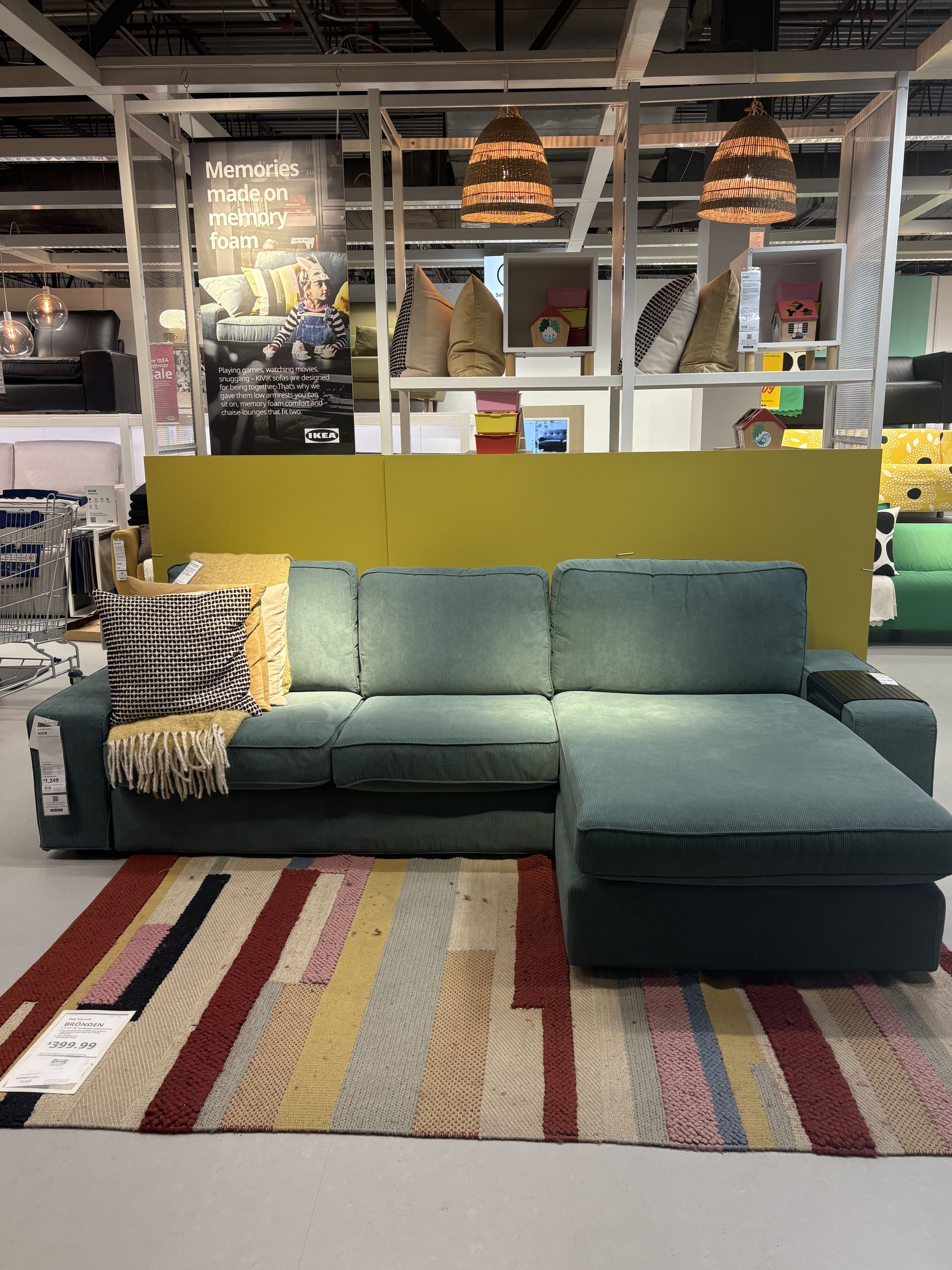 A blue sectional sofa sitting in an IKEA showroom.