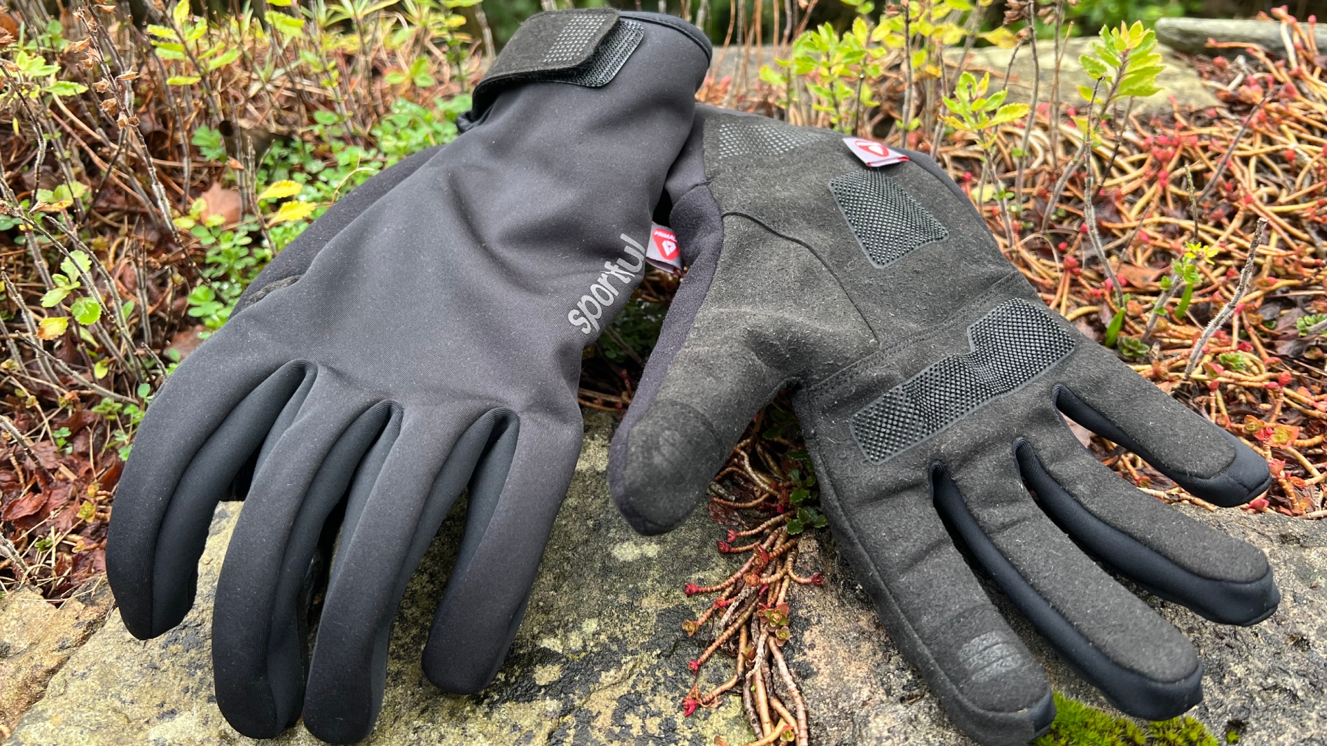 A pair of the Sportful Deep Winter Gloves shown laying on some greenary 