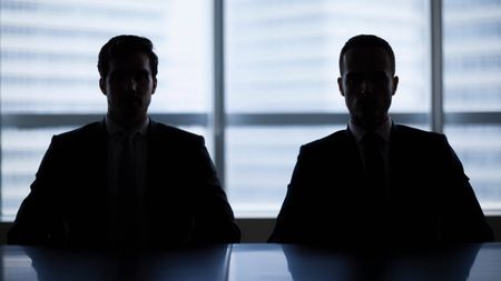 Silhouette pair of businessmen in meeting room
