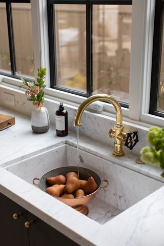 marble worktop and sink with brass tap
