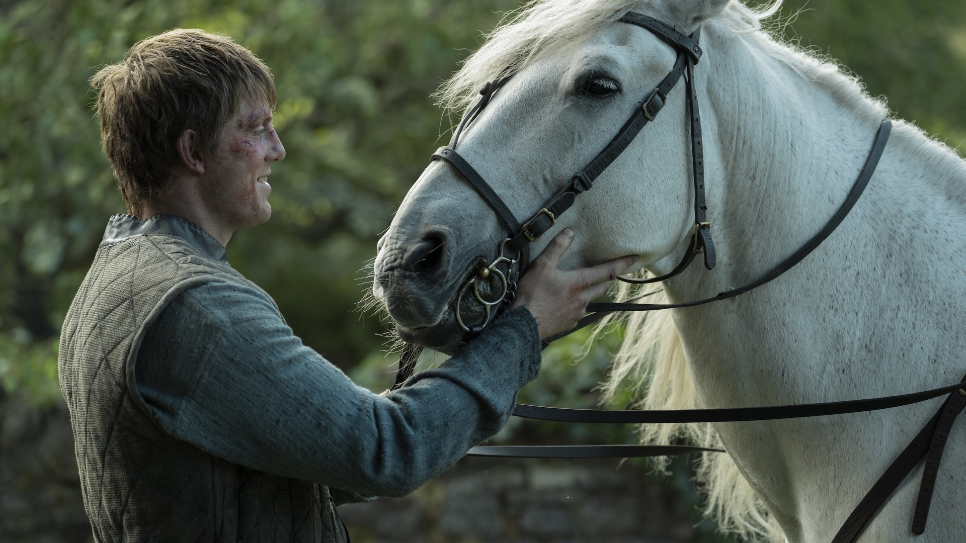 Dunk (Peter claffey) holds a horse in a scene from "A Knight of the Seven Kingdoms" episode 6
