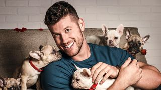 The Bachelor Clayton Echard poses with puppies on season 26 poster art
