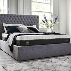 Emma Select Diamond Hybrid mattress on a grey bed base and headpiece in a room with flowers