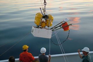 Scientists on a research vessel lower an ocean-bottom seismometer into the Mediterranean Sea, beginning a yearlong hunt for seismic activity on the seafloor.