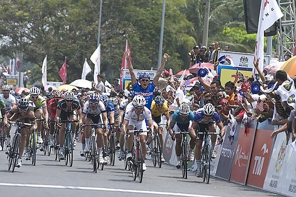 The celebrations begin for the Aisan Racing Team as Taiji Nishitani (white) heads towards victory.