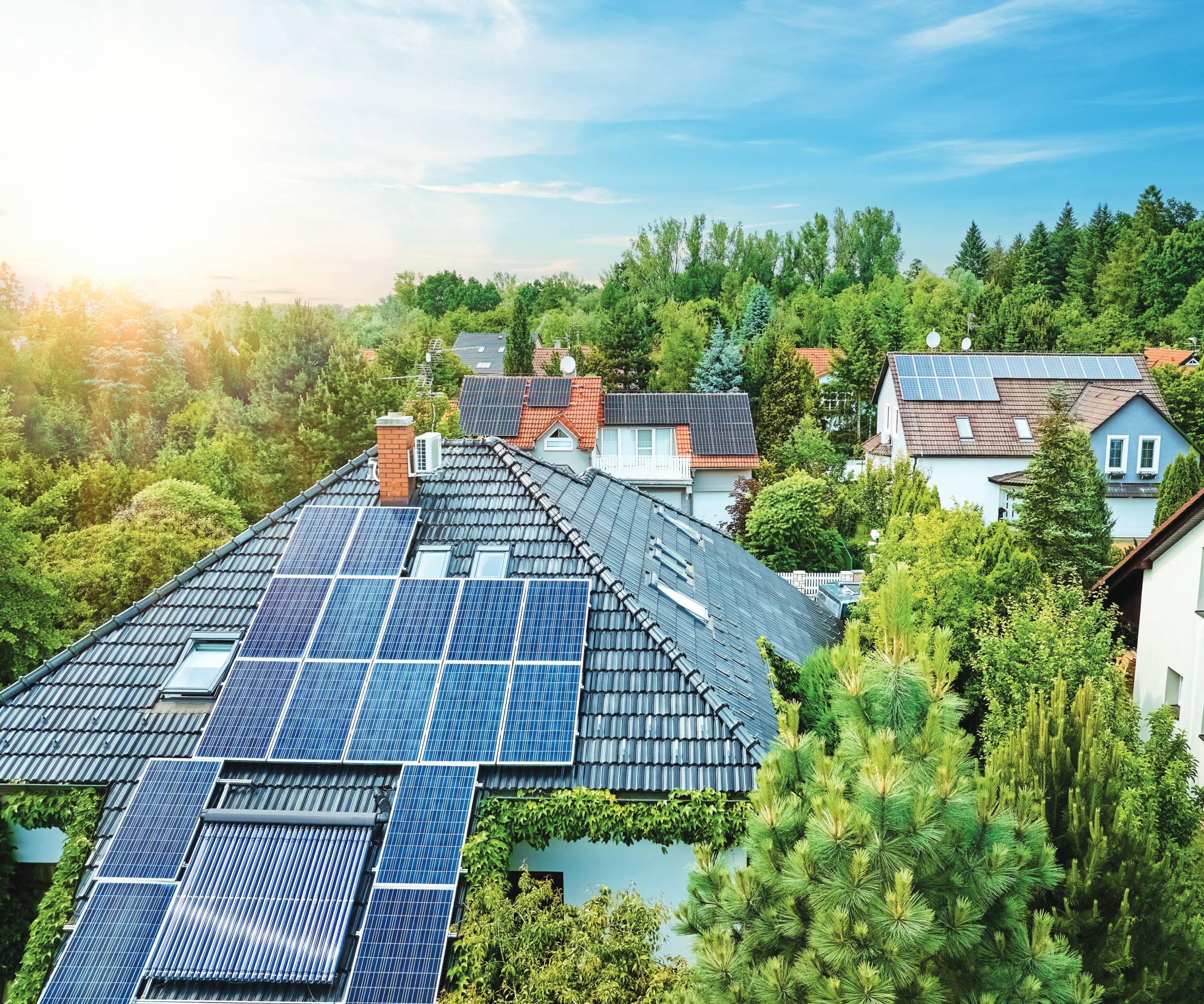 birds eye view of houses with solar panels on roof of one home