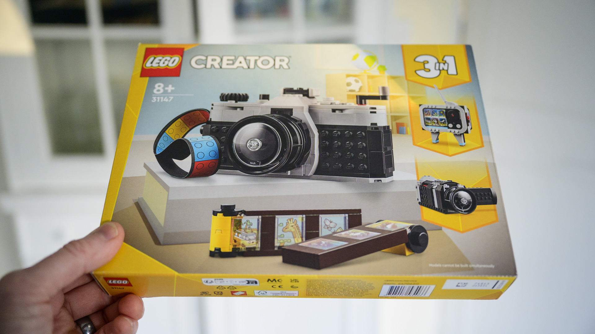 The unopened box of the Close up of the top plate of the completed Lego Retro camera set
