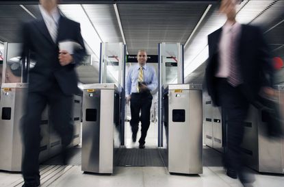 Businessman Running Through Subway Turnstile