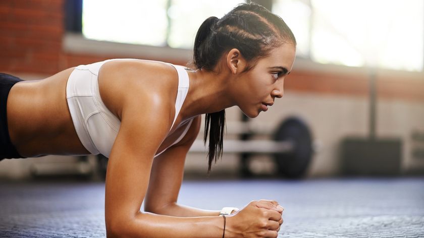 a photo of a woman holding a plank
