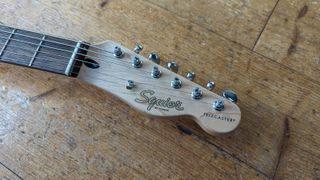 The headstock of a Squier Paranormal Baritone Cabronita Telecaster