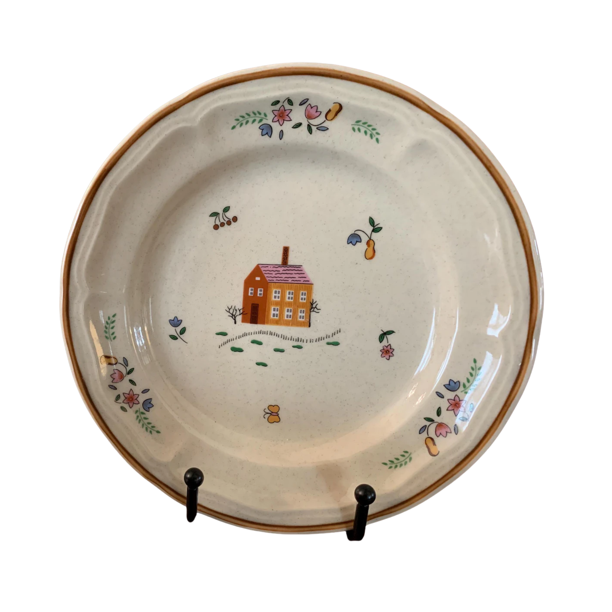 a vintage plate with a house in the middle