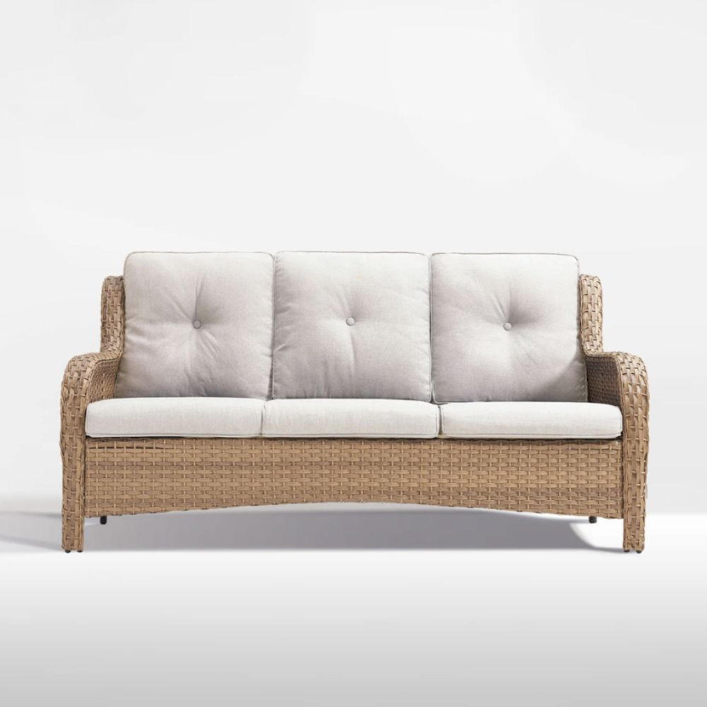 Wicker outdoor sofa with cream cushions