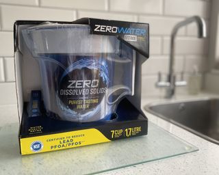 A pack shot of ZeroWater water filter jug on glass cutting board
