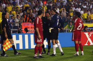 Turkey's Hakan Unsal is shown the red card for kicking the ball at Brazil forward Rivaldo in a group game at the 2002 World Cup.