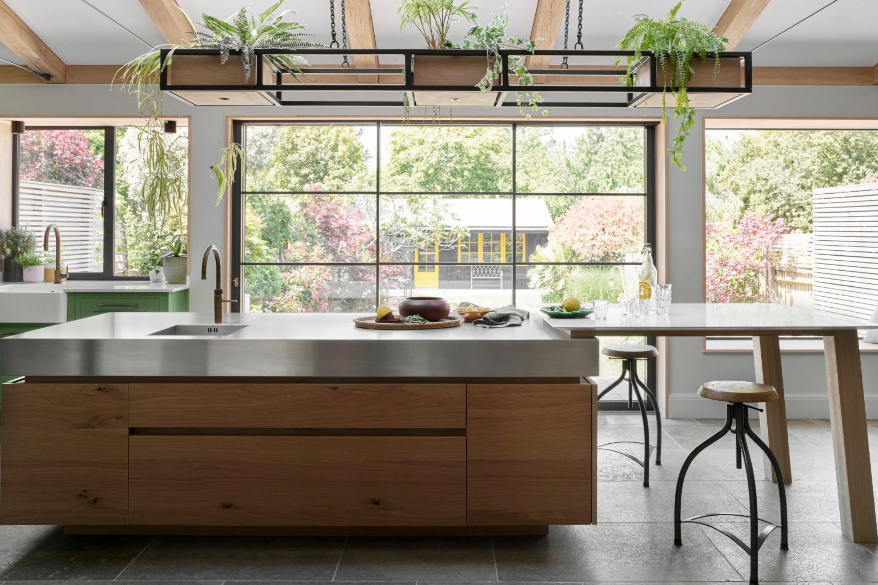 kitchen with stainless steel countertops and kitchen island by Roundhouse