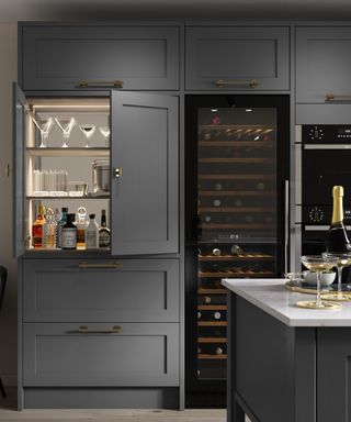dark grey kitchen cabinets with tall wine cooler and bar area in cupboard