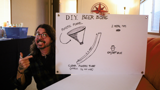 Dave Grohl holding one of the drawings he made for the Sea.Hear.Now charity auction