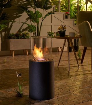 A floor standing fire pit on a living room floor
