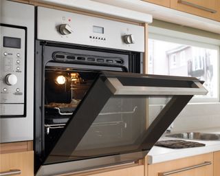 An open oven in bright kitchen
