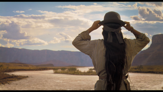 Making the invisible VFX of Horizon: An American Saga - Chapter 1; a Native American adjusts their hat and looks out over the river