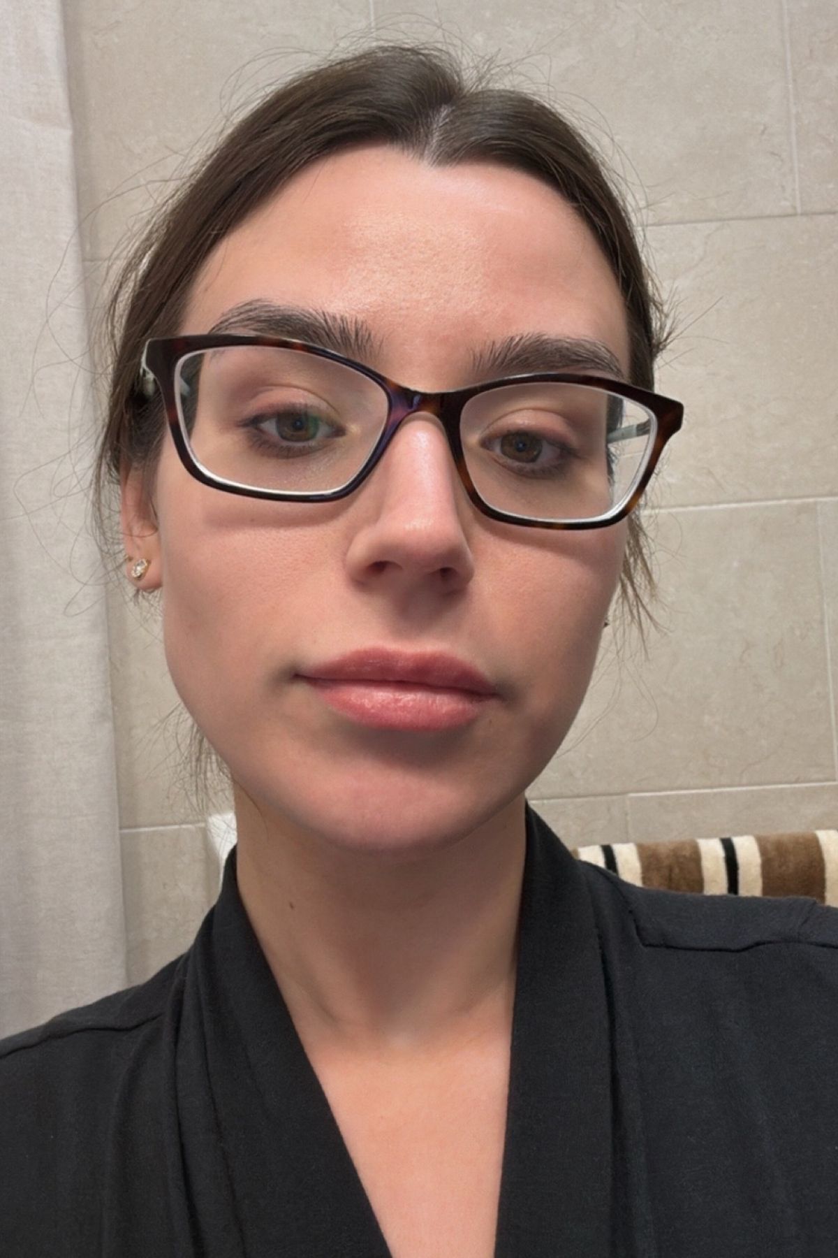 Siena Gagliano before testing the Giorgio Armani Luminous Silk Natural Glow Foundation in a black robe and glasses.