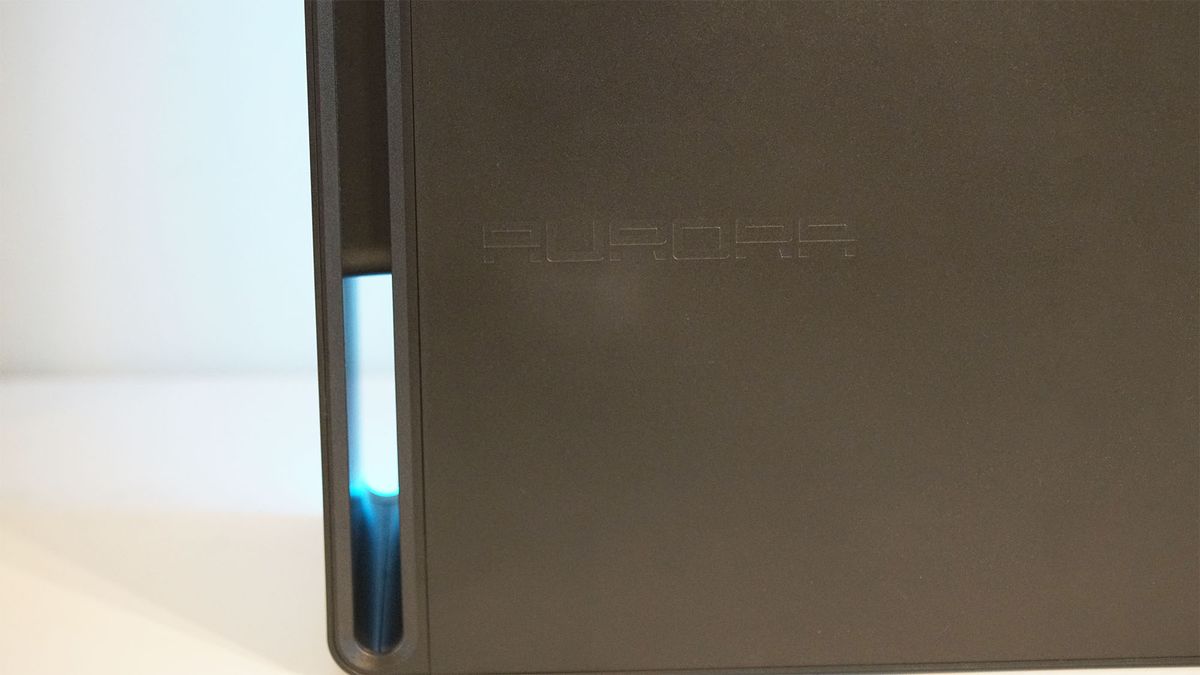 An Alienware Aurora gaming desktop on a desk with a view of the Aurora branding