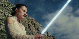 Rey on Ahch-To practicing with a lightsaber