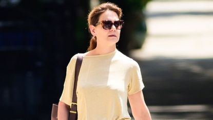 Katie Holmes in New York City wearing the butter yellow trend t shirt with a pair of jeans and sunglasses