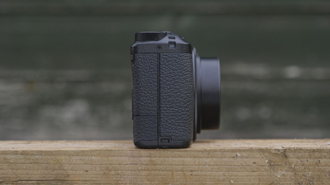 The Ricoh GR IIIx camera on a wooden table