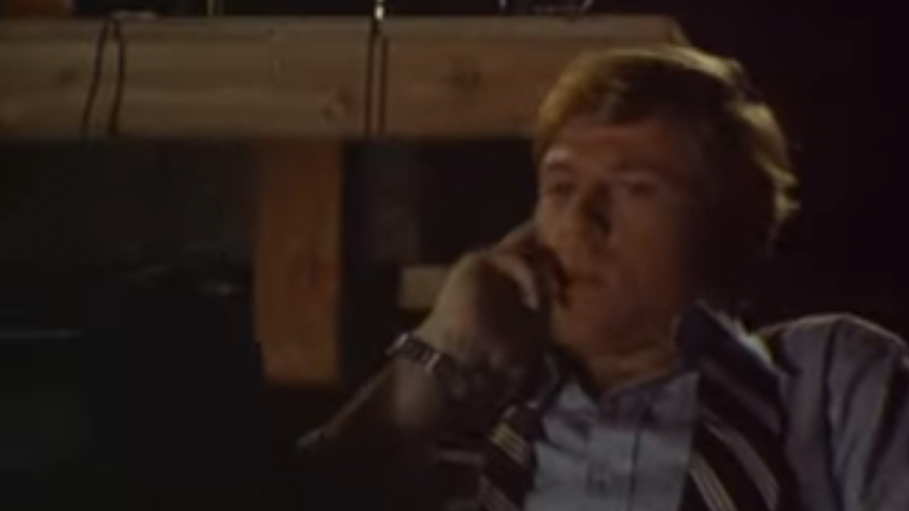 Robert Redford, thinking, with a finger near his mouth in The Candidate