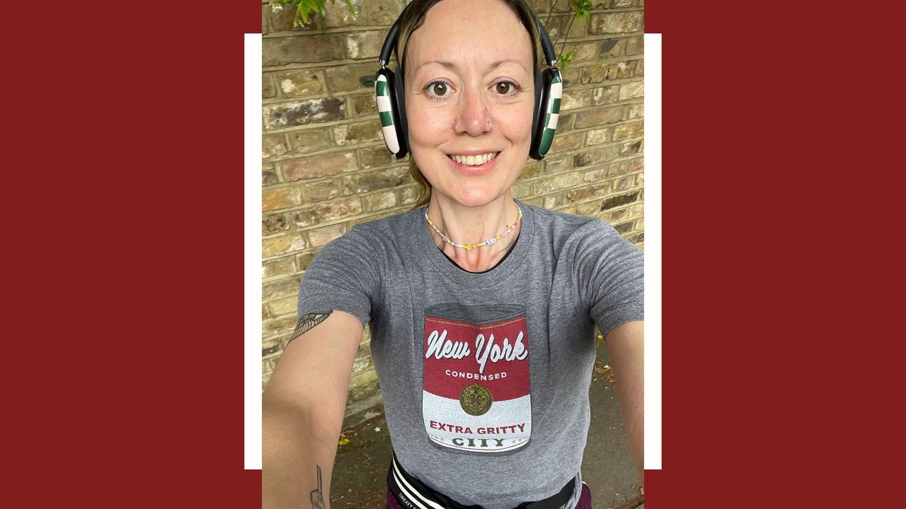 Jen Barton selfie standing up against a brick wall after going on a run