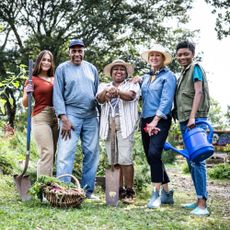 group of volunteers in front of a community garden