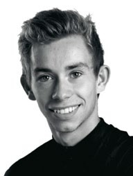 A portrait of Chris Marshall-Bell, a cycling journalist, smiling against a plain background.