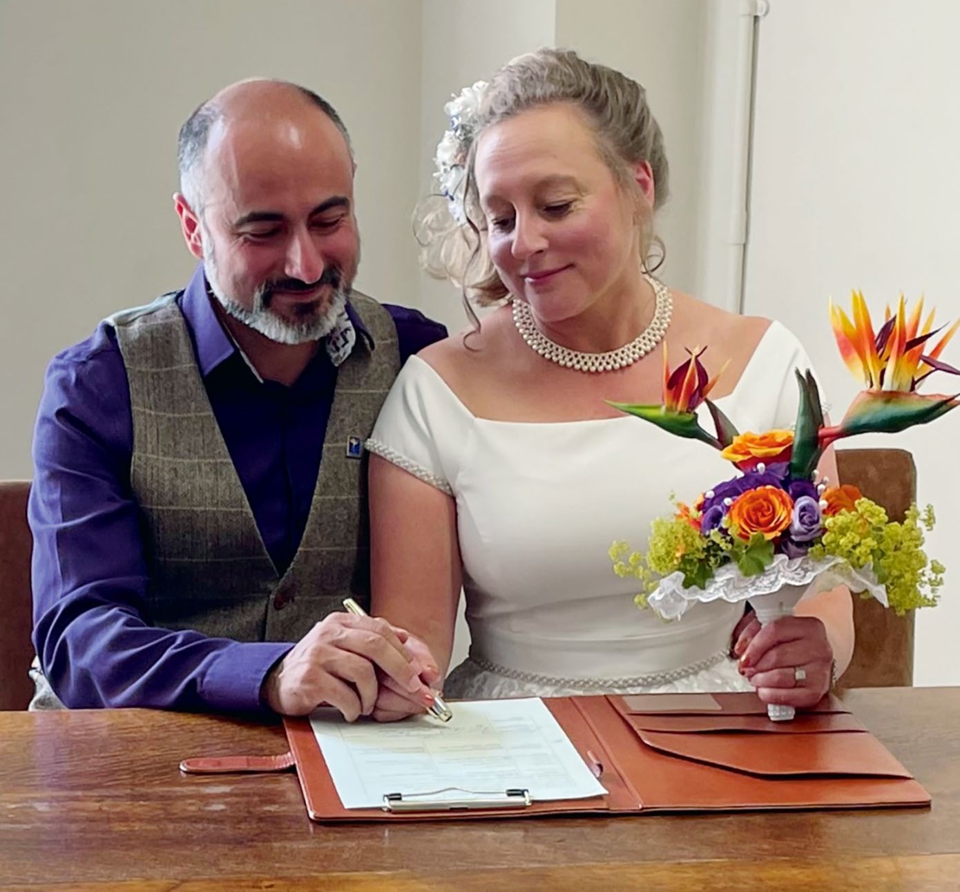 Alison Wainwright and Helder signing the register at their wedding ceremony