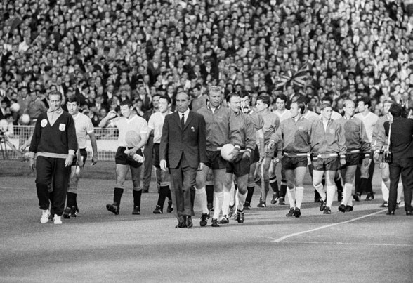 The opening match of the 1966 World Cup tournament between England and South Americans Uruguay at Wembley ended in a disappointing goalless draw and frustration for the host nation, the two teams are led out onto the pitch by managers Ondino Viera and Alf Ramsey for the first round Group A match, 11th July 1966. (Photo by Daily Mirror/Mirrorpix via Getty Images)