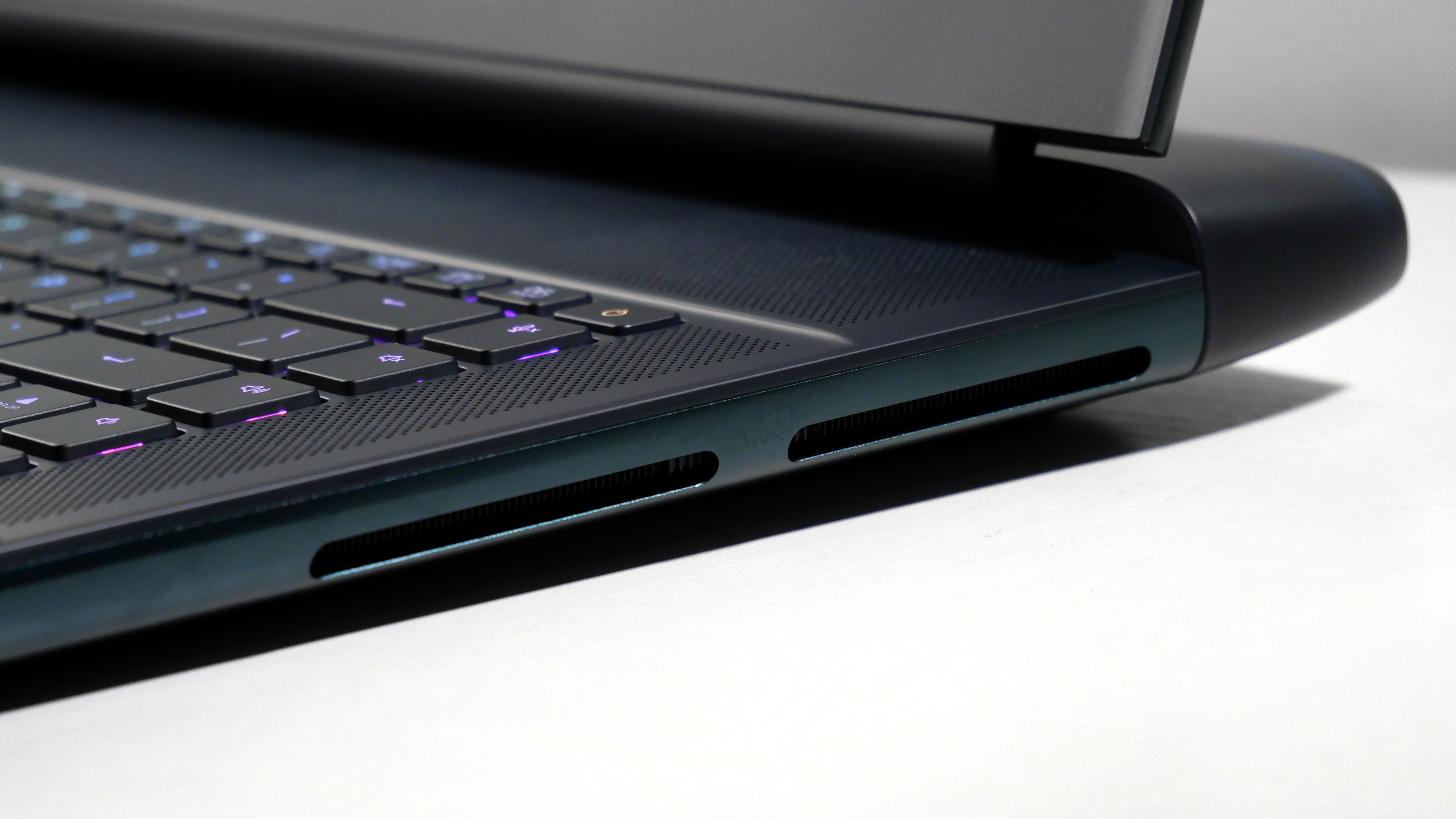 Alienware 16 Area-51 (RTX 5080) open on a white desk, highlighting the vents on the right.