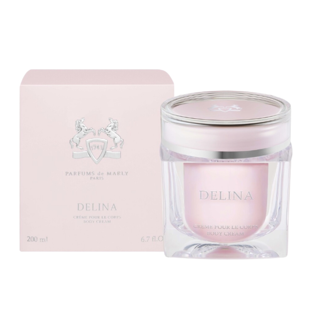 A product shot of the Parfums de Marly Delina body cream, alongside its pink box, on a white background