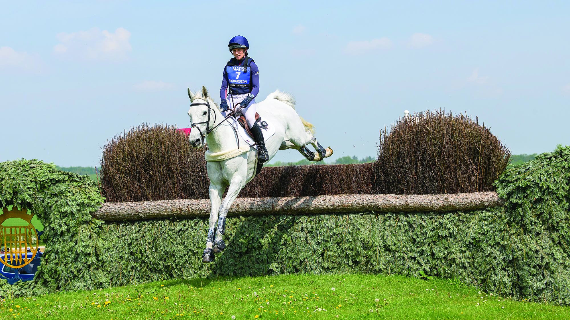 Holly Richardson and Ballyneety Silver Service jump a cross-country fence at Badminton Horse Trials 2026.