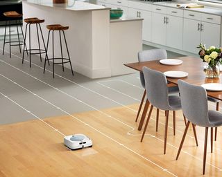 iRobot Brava M6 mop in an open plan kitchen diner with hard and wood flooring