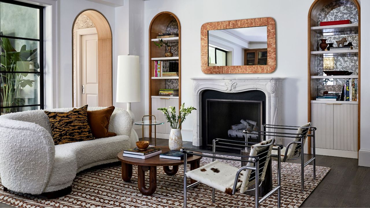 living room with light grey walls, fireplace and rounded top alcoves white boucle sofa, 