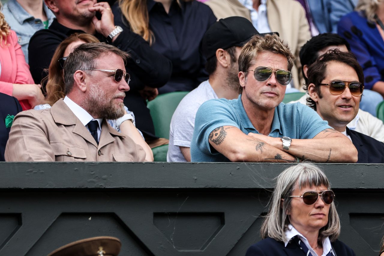 Guy Ritchie and Brad Pitt watching tennis