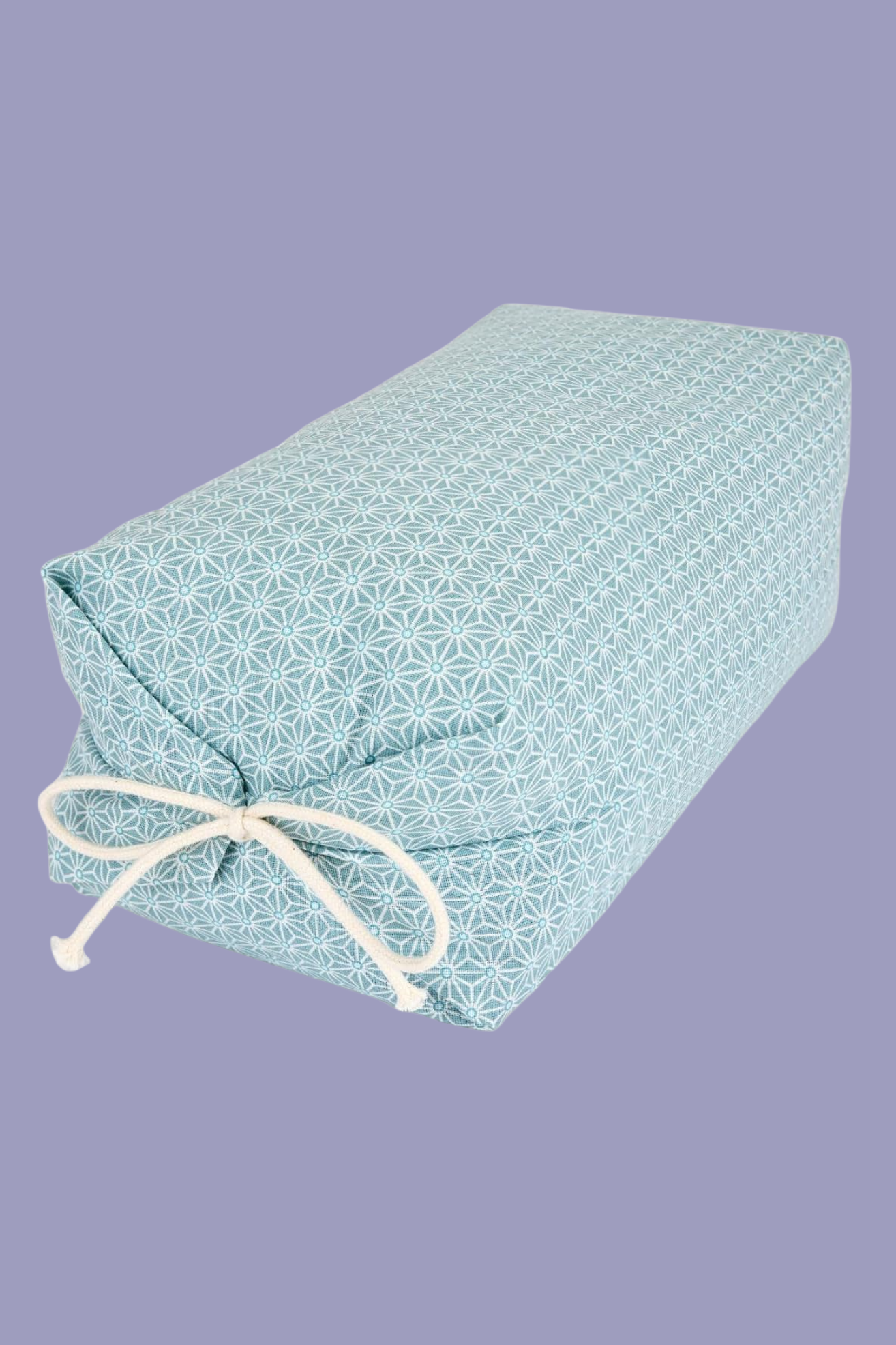 A square buckwheat pillow with a patterned case