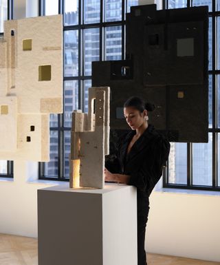 A portrait of designer Maryam Turkey alongside her work, photographed at Carpenters Workshop Gallery
