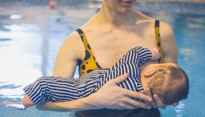 mother breastfeeding in pool