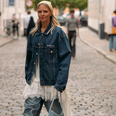 woman wearing.a denim jacket over jeans in Copenhagen