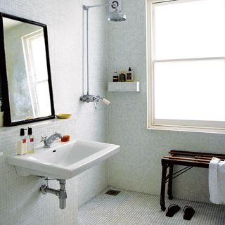 bathroom with white wasbasin and mirror on wall