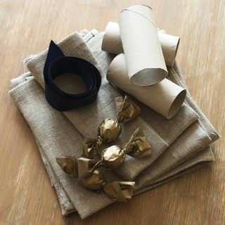Linen napkin with loo rolls, ribbon and chocolates